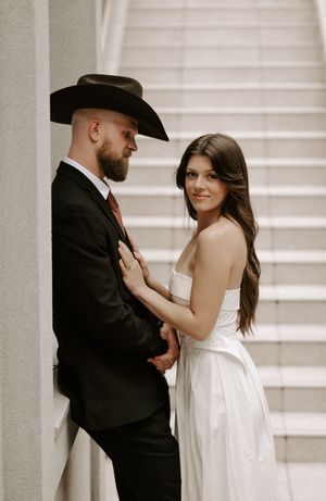 Series of romantic wedding photos showing a couple in western-inspired formal attire against white walls.