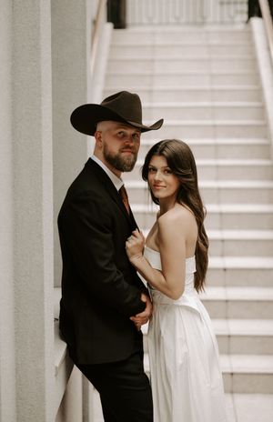 Candid wedding moments captured in a series of intimate poses against a bright architectural backdrop.
