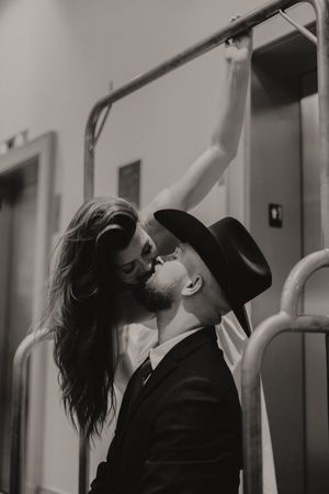 Artistic black and white photos of a couple in formal wear sharing intimate moments.