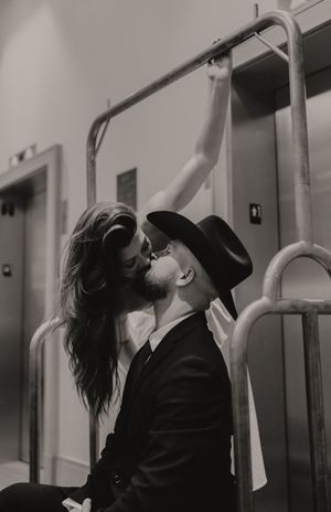 Dramatic black and white photos of a couple in formal wear against a light background.