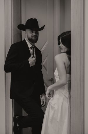 A series of black and white photos capturing romantic moments in a hallway setting.