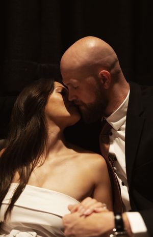 Romantic moment captured in dramatic lighting between two people.