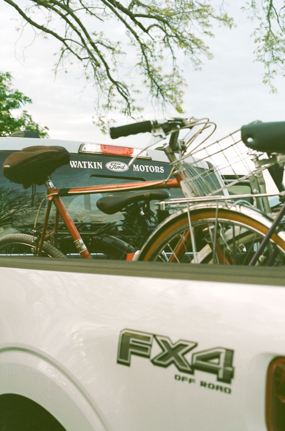 A vintage-style Watkin Motors bicycle mounted on an FX4 truck.