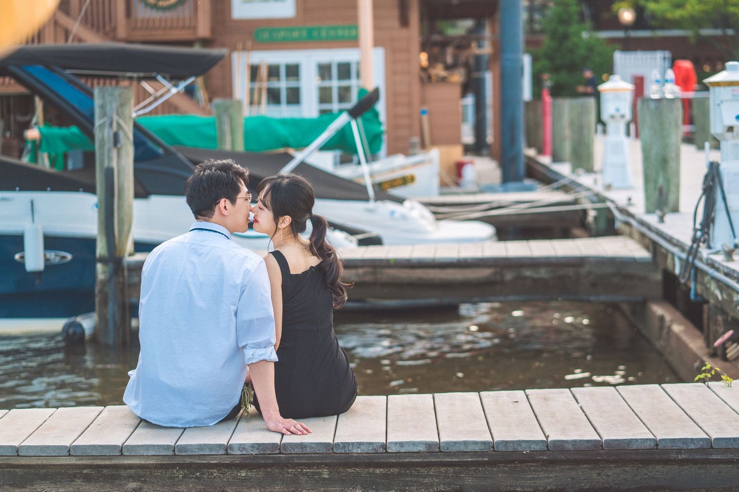 Four consecutive photos show people sitting on a wooden dock by a canal on a peaceful summer day.