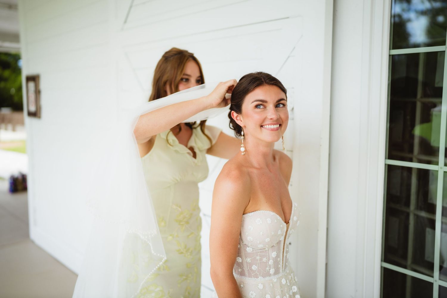 Final preparations take place as a bride in a strapless white gown gets ready at an elegant venue.
