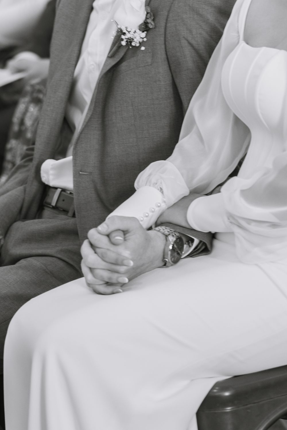 Black and white detail shots of couple during wedding ceremony.