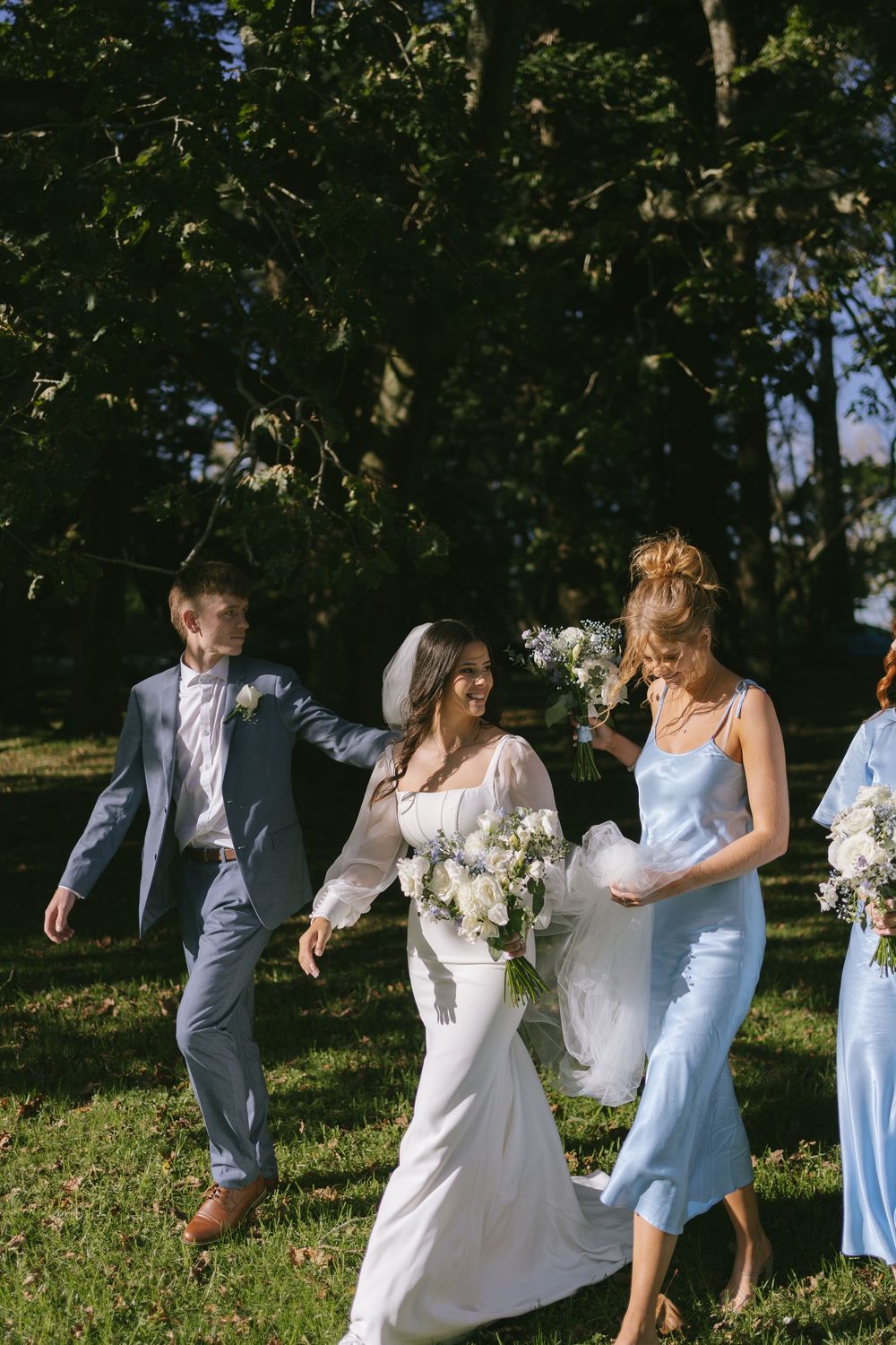 Candid wedding party photos showing joyful moments on grassy hillside.