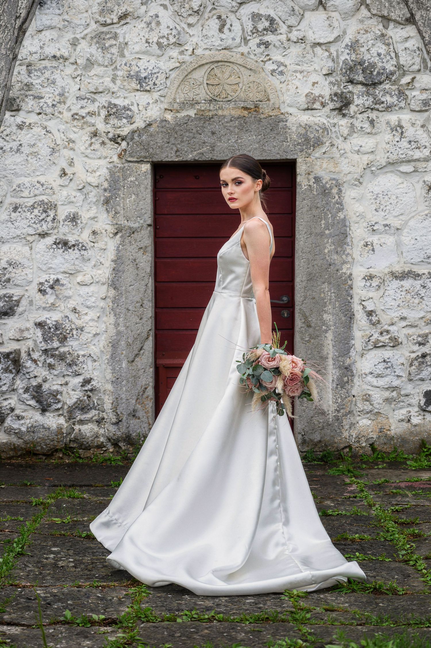 Moody black and white silhouettes by arched windows create atmospheric wedding photography sequence.