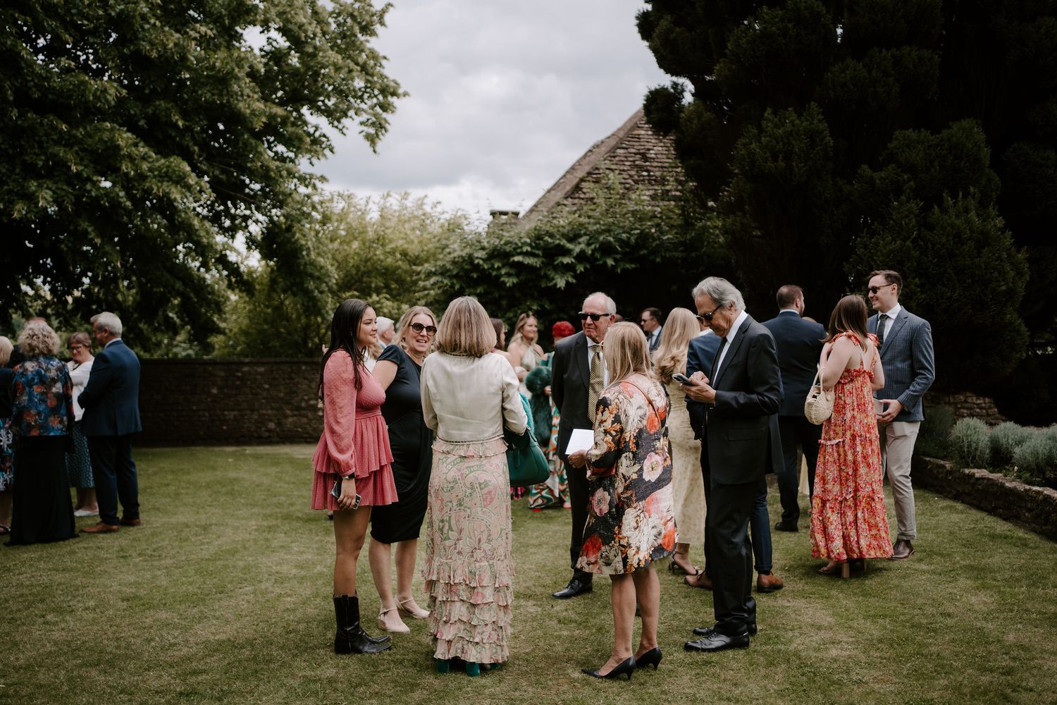 wedding guests talking and laughing at Hamswell house in bath