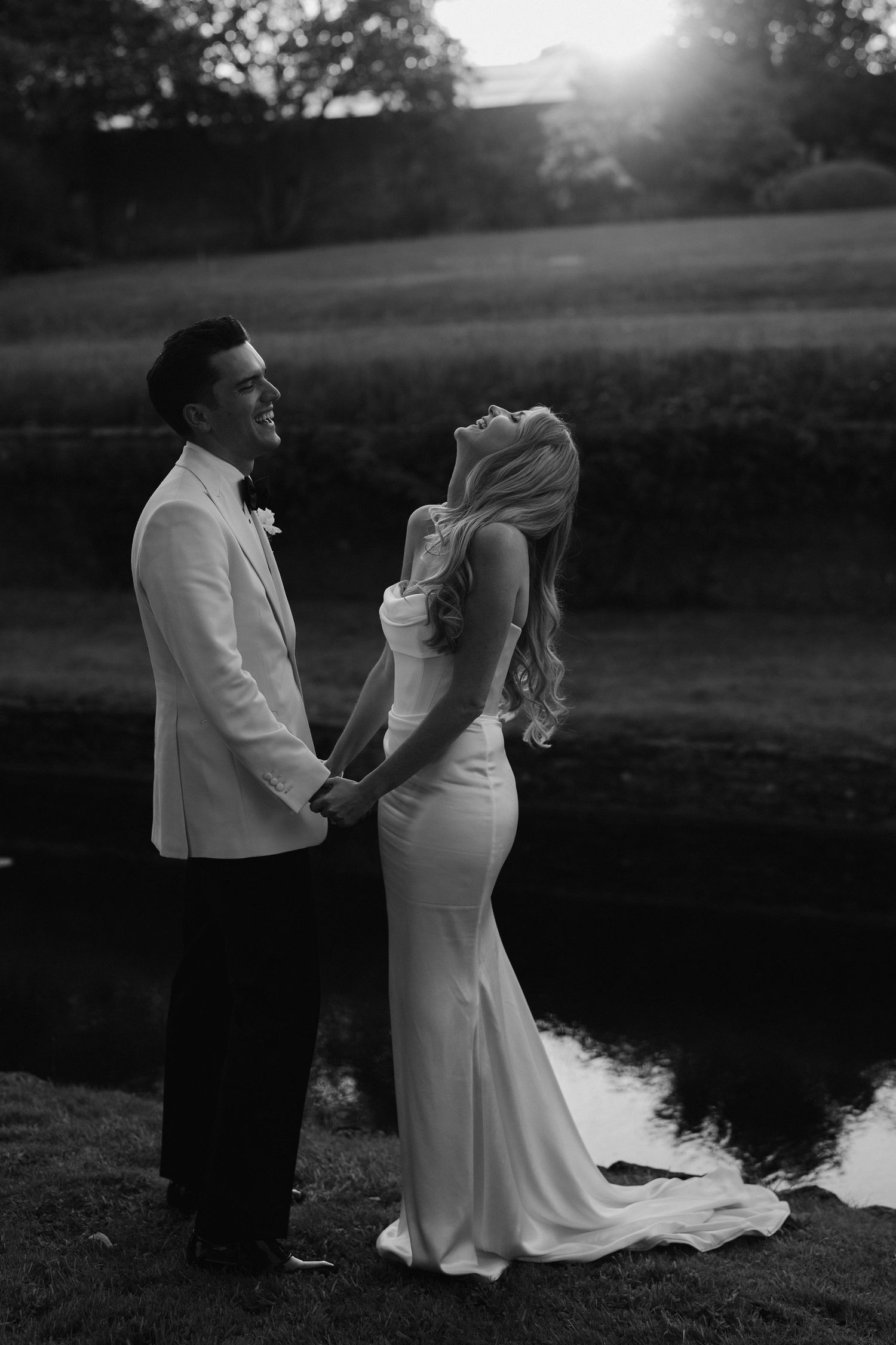 bride throwing head back laughing with groom at hamswell house wedding in bath