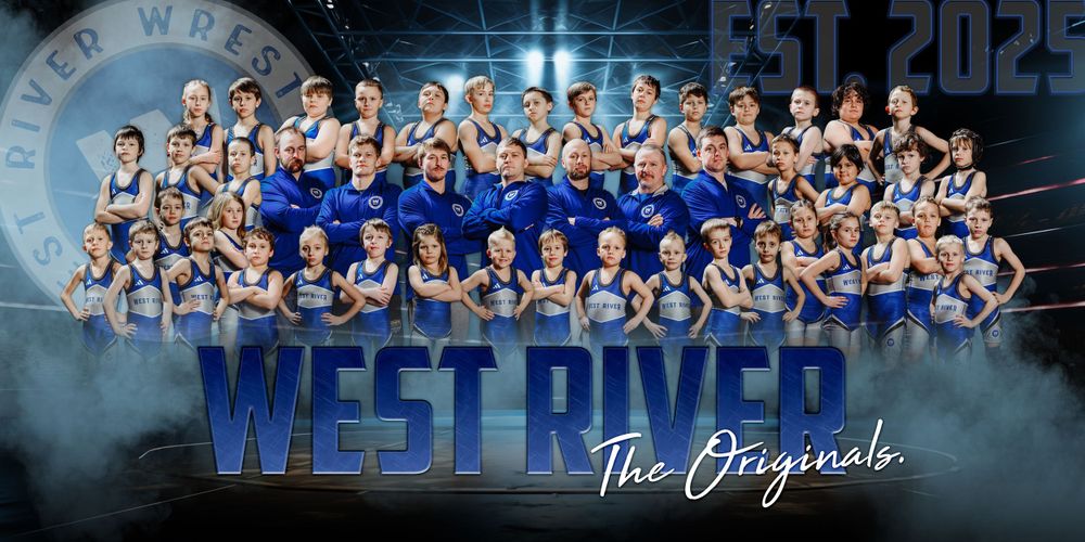A large group sports team poses together in blue uniforms with special effects smoke and dramatic lighting on a dark background.