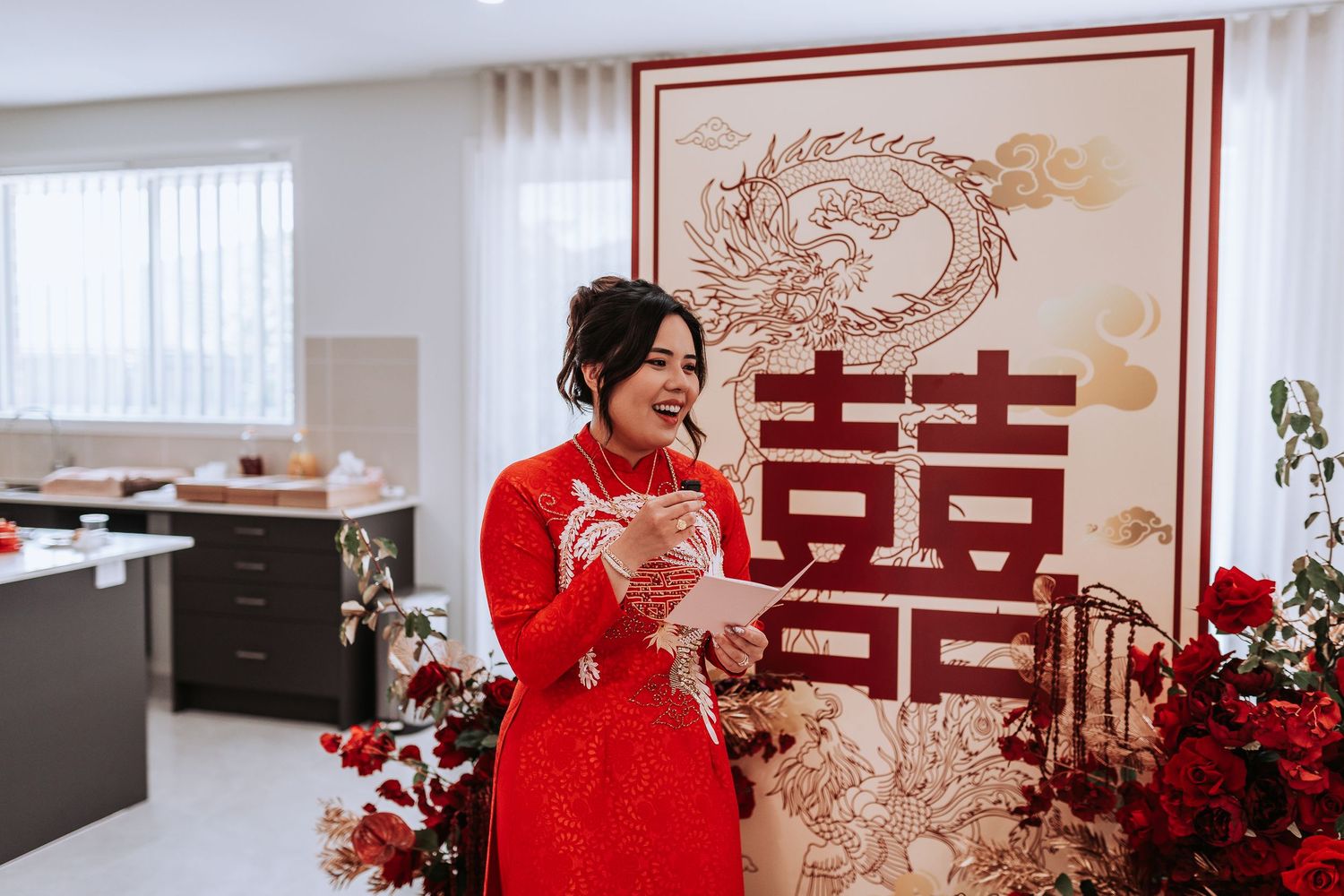 Traditional Chinese wedding ceremony decor features double happiness symbol and dragon artwork with red and gold motifs.
