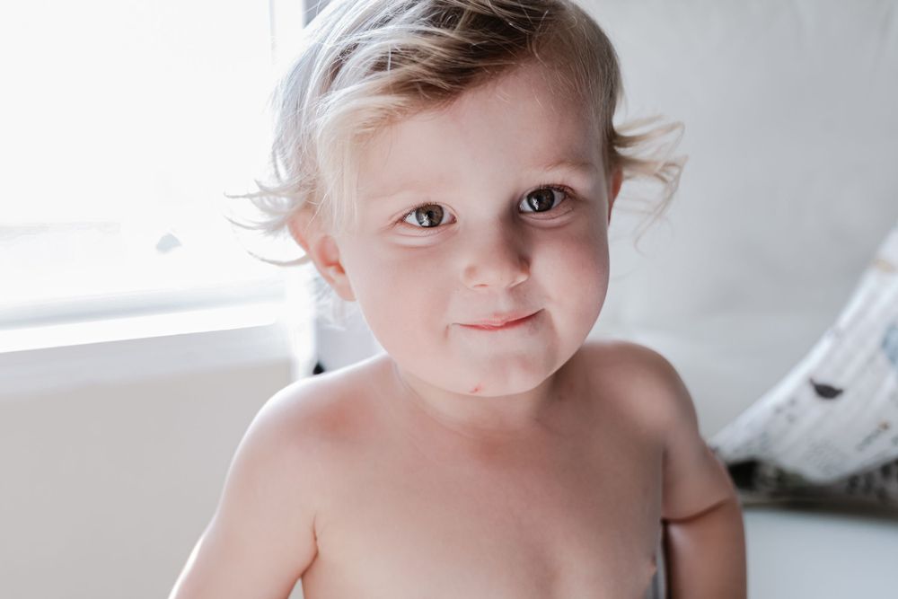 A close-up portrait against a white background.