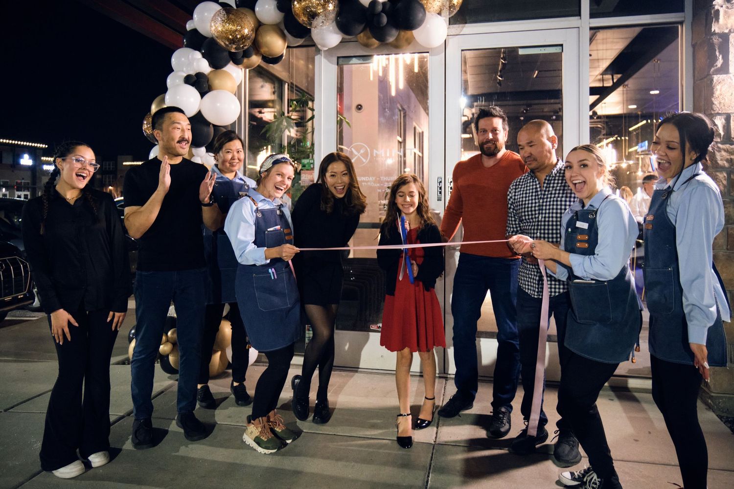 Grand opening ribbon cutting event with the restaurant staff.
