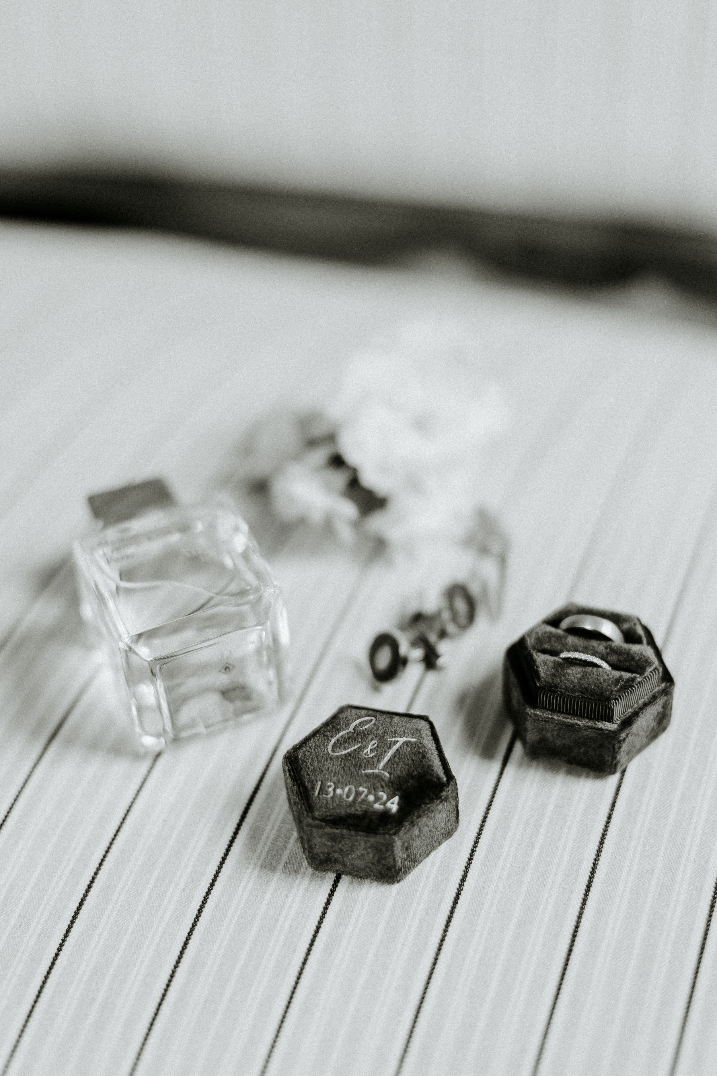 Black and clear gaming dice arranged on a white striped surface in a minimalist composition.