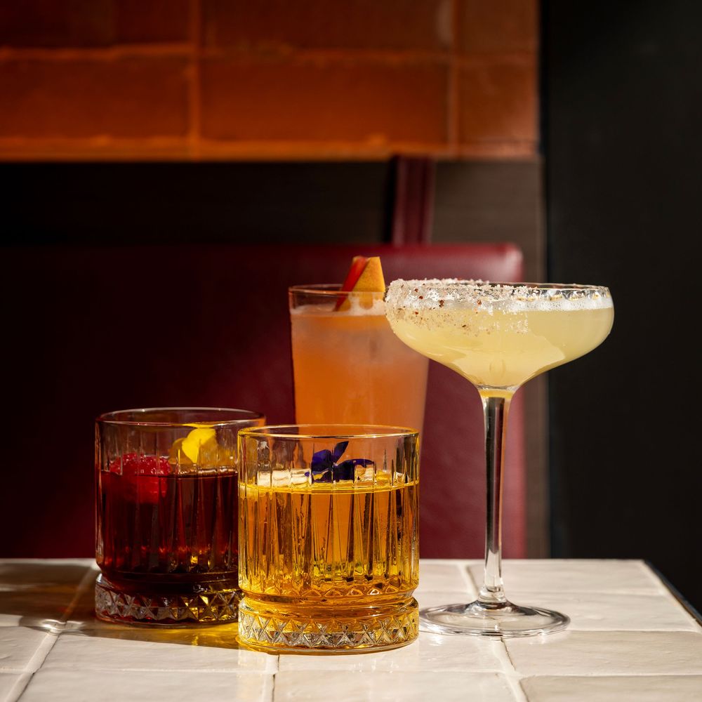 Margarita
Negroni
watermelon cocktail
sitting on a white tile background with red in the background