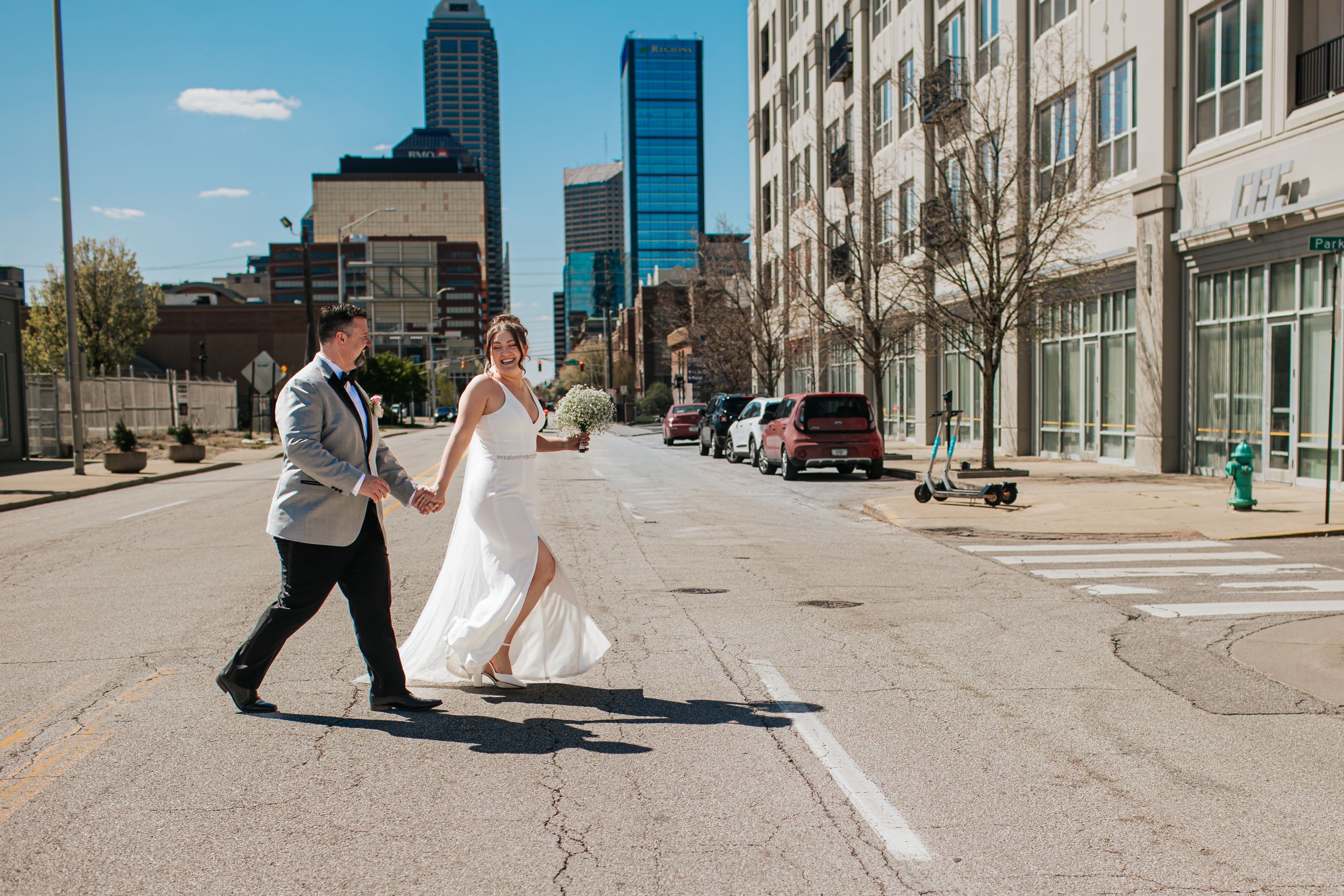 People walking on a sidewalk in front of modern office buildings on a sunny day.