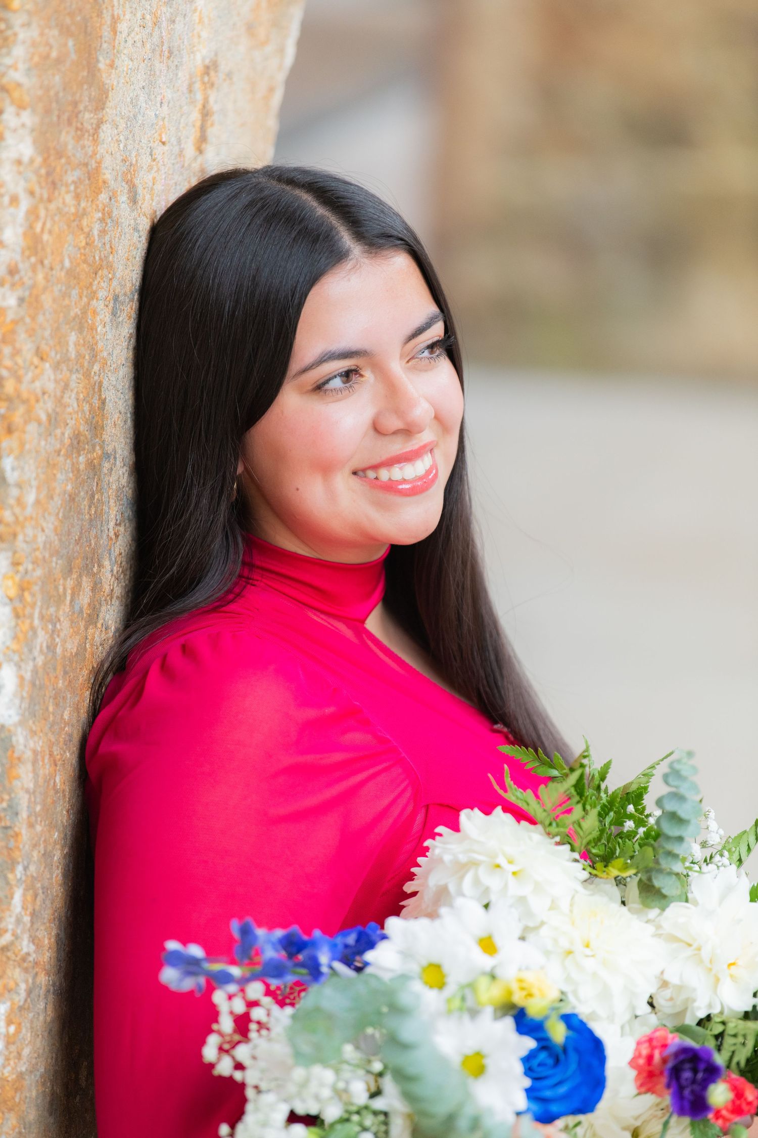 Senior girl dressed in a stunning dance outfit, surrounded by a vibrant bouquet of flowers, capturing a moment of pure beauty and grace.