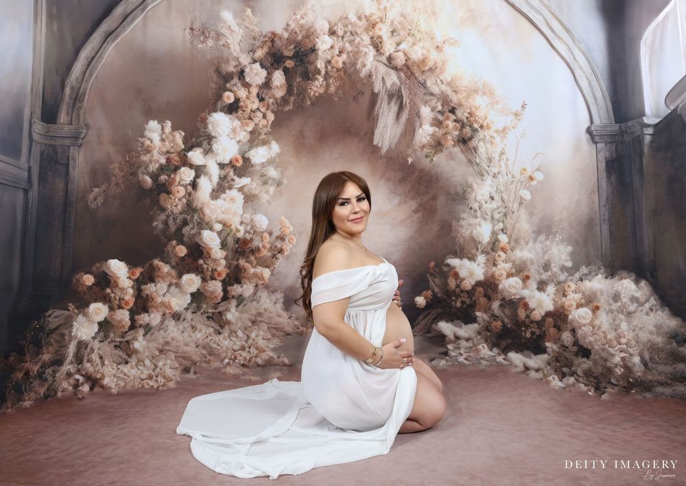 Wedding photoshoot featuring vintage-inspired floral arches and a romantic, ethereal atmosphere in a studio setting.