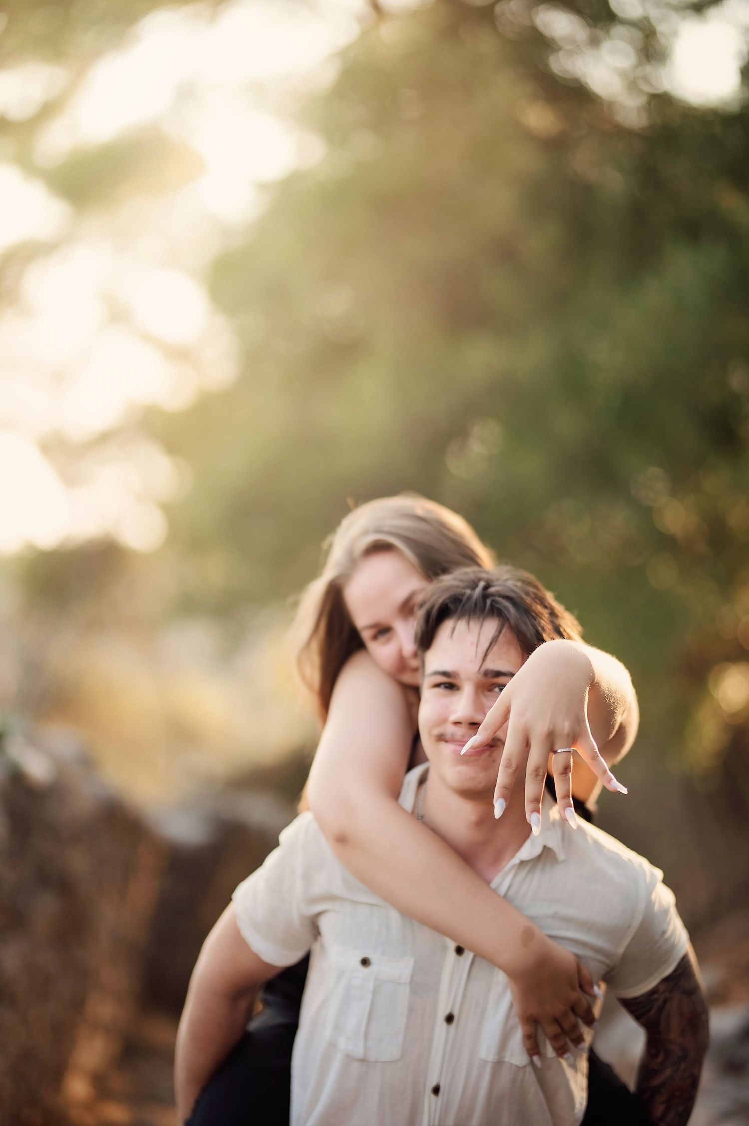 A tender embrace captured in golden hour lighting with bokeh effects.