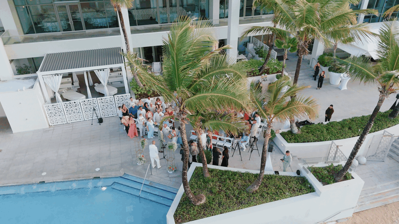 Beachfront wedding ceremony with infinity pool and ocean views — tropical destination wedding | POST-TALES WEDDS.