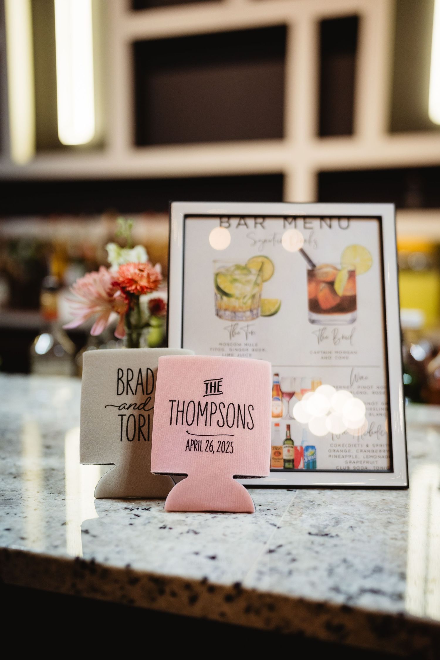 Wedding reception details including a bar menu and custom pink drink koozie for the Thompsons' special day.