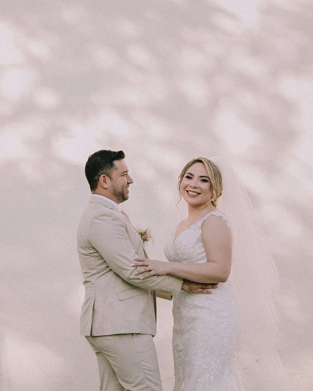 Romantic candid moments between newlyweds in soft, dreamy lighting.