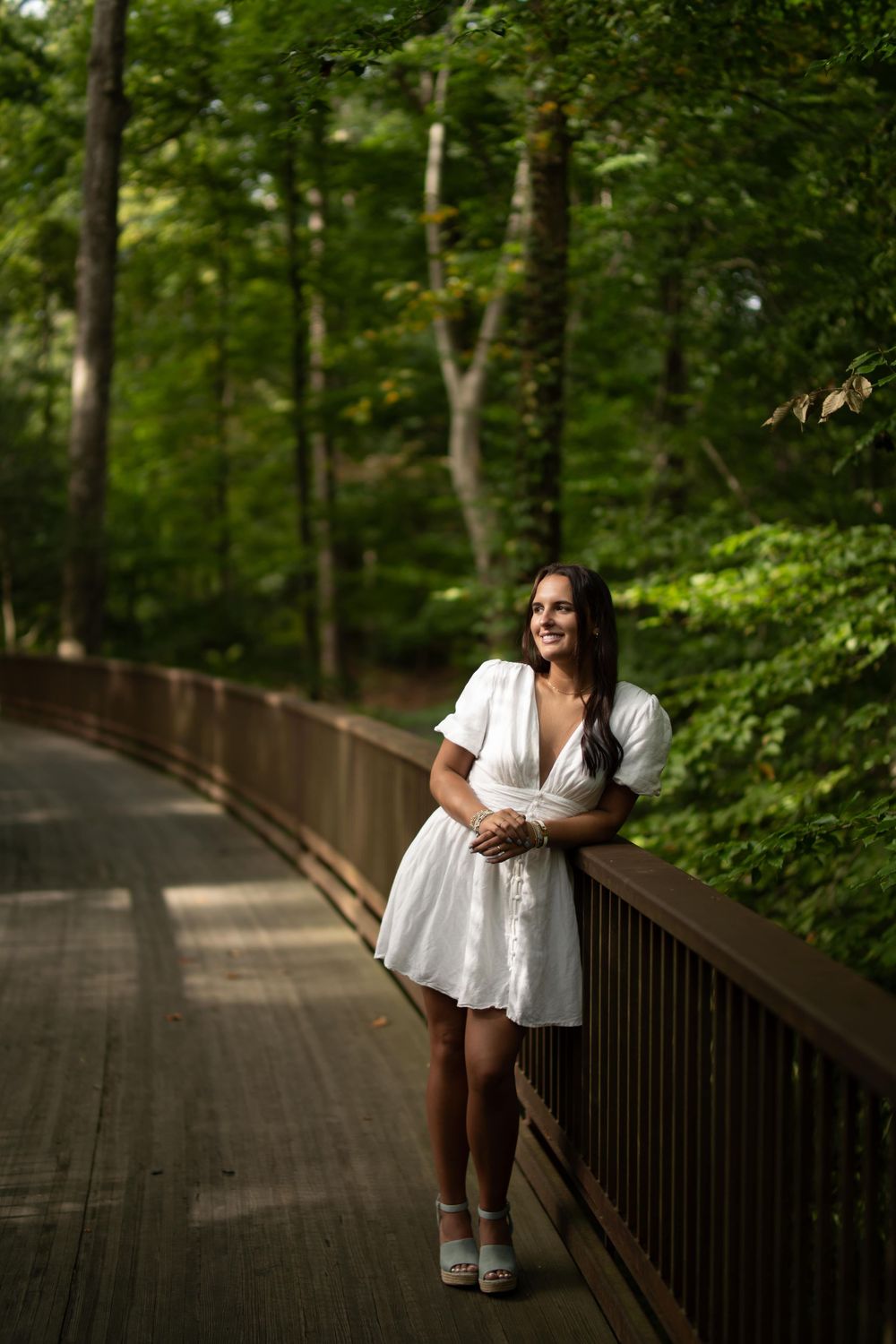 High school senior at the Atlanta History Center for senior photos on a wooden bridge