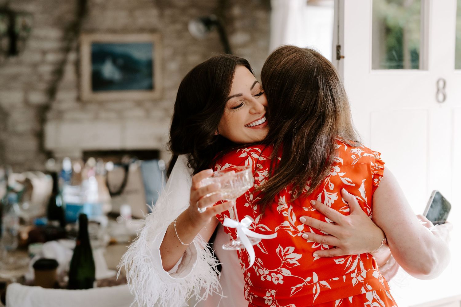 bride hugging friend at the new inn cirencester