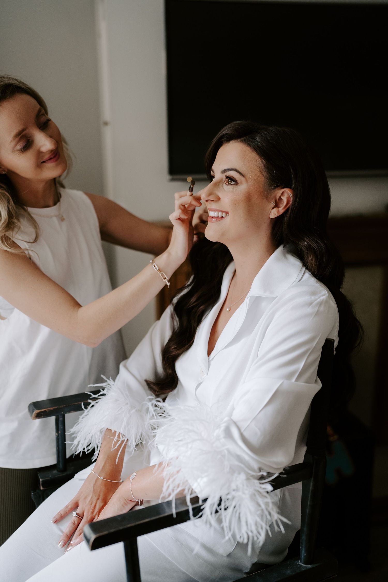 bride getting wedding make up during bridal preparation for wedding in cirencester
