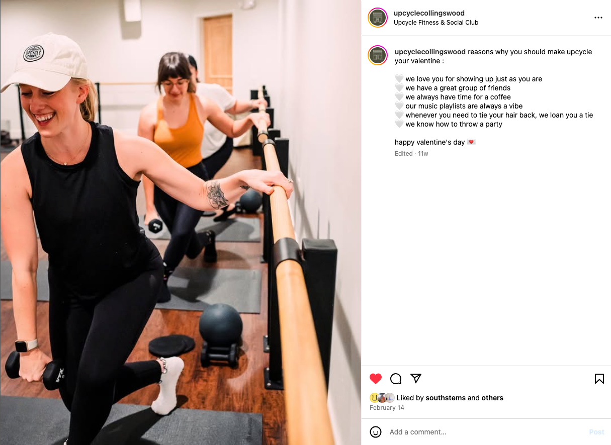 Two people exercise in a gym space using various fitness equipment and weights.