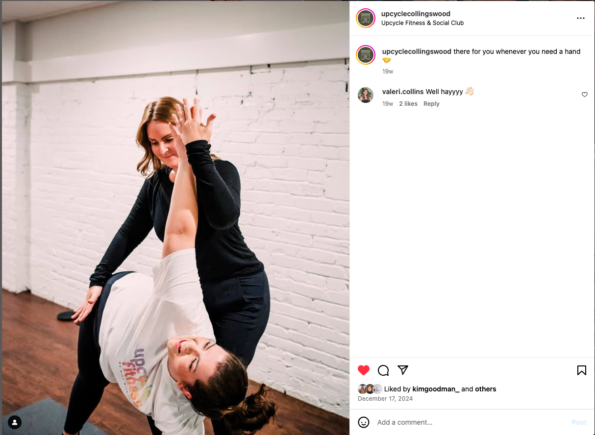 Dance partners practicing movement together in a bright studio with white brick walls.