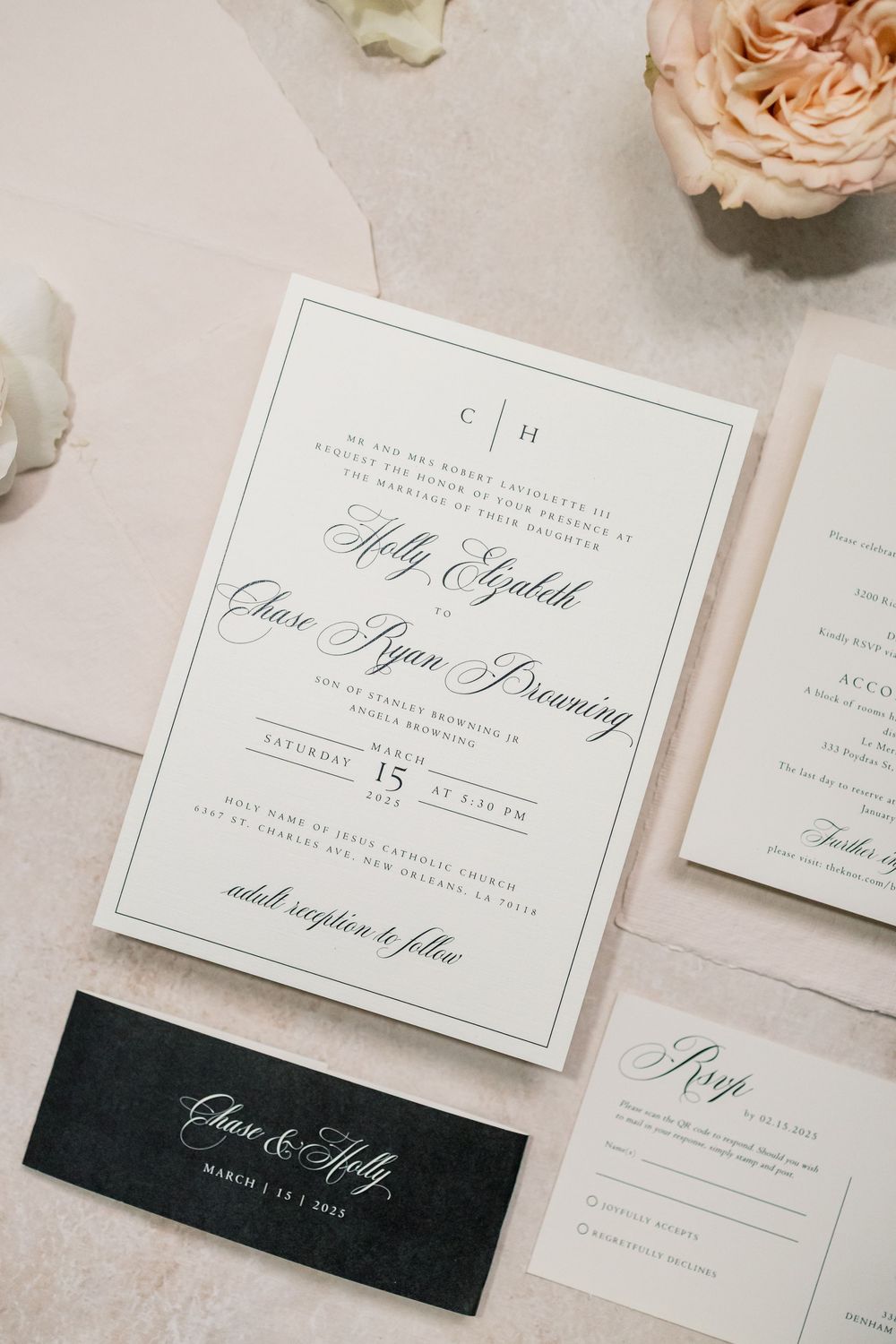 Elegant wedding invitation suite with classic black and white design featuring delicate calligraphy and blush roses.