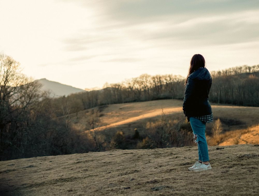 Mountain landscape with woman looking in the distance
