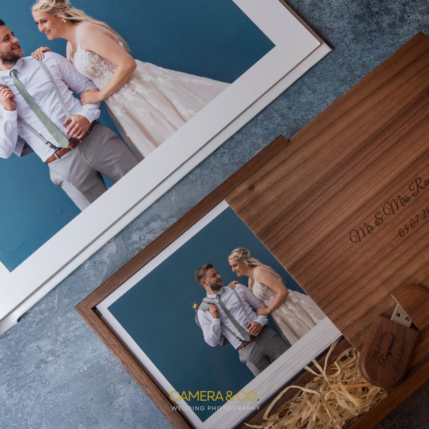 Wedding photo album layout with blue background and wooden accents.
