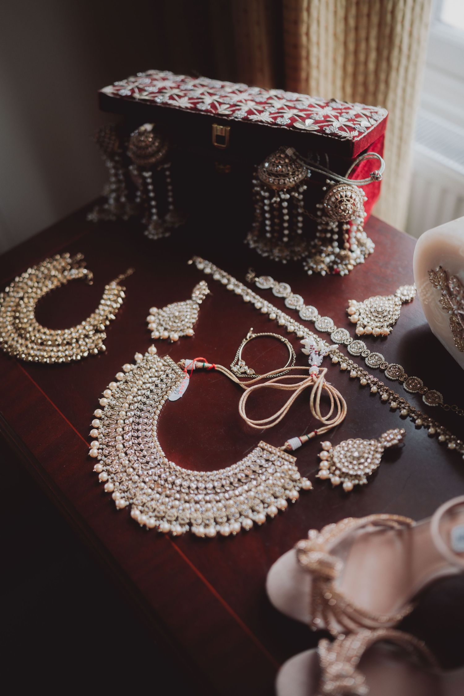 Elegant silver and pearl Indian wedding jewelry set with traditional necklaces and earrings.