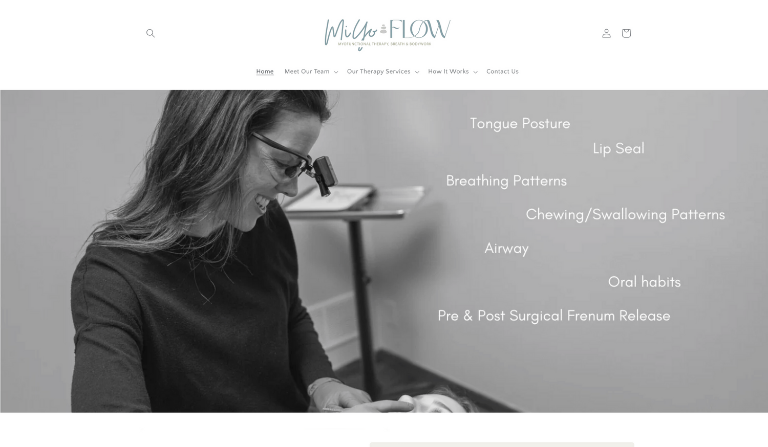 A professional works at a modern medical office desk with a sleek grayscale design theme.