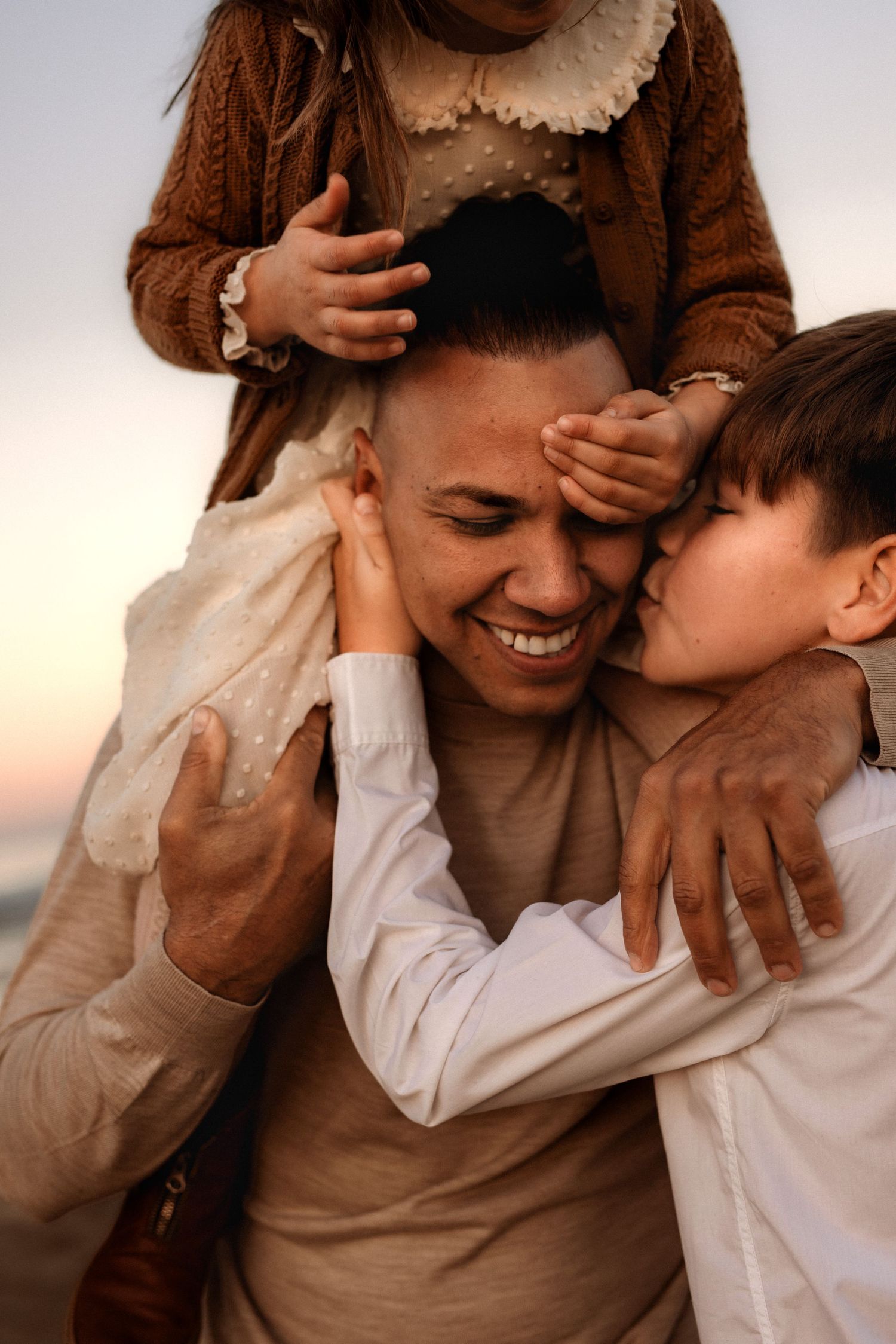 Joyful moment in Javea of a  family affection and laughter during outdoor sunset photoshoot. Java family photographer