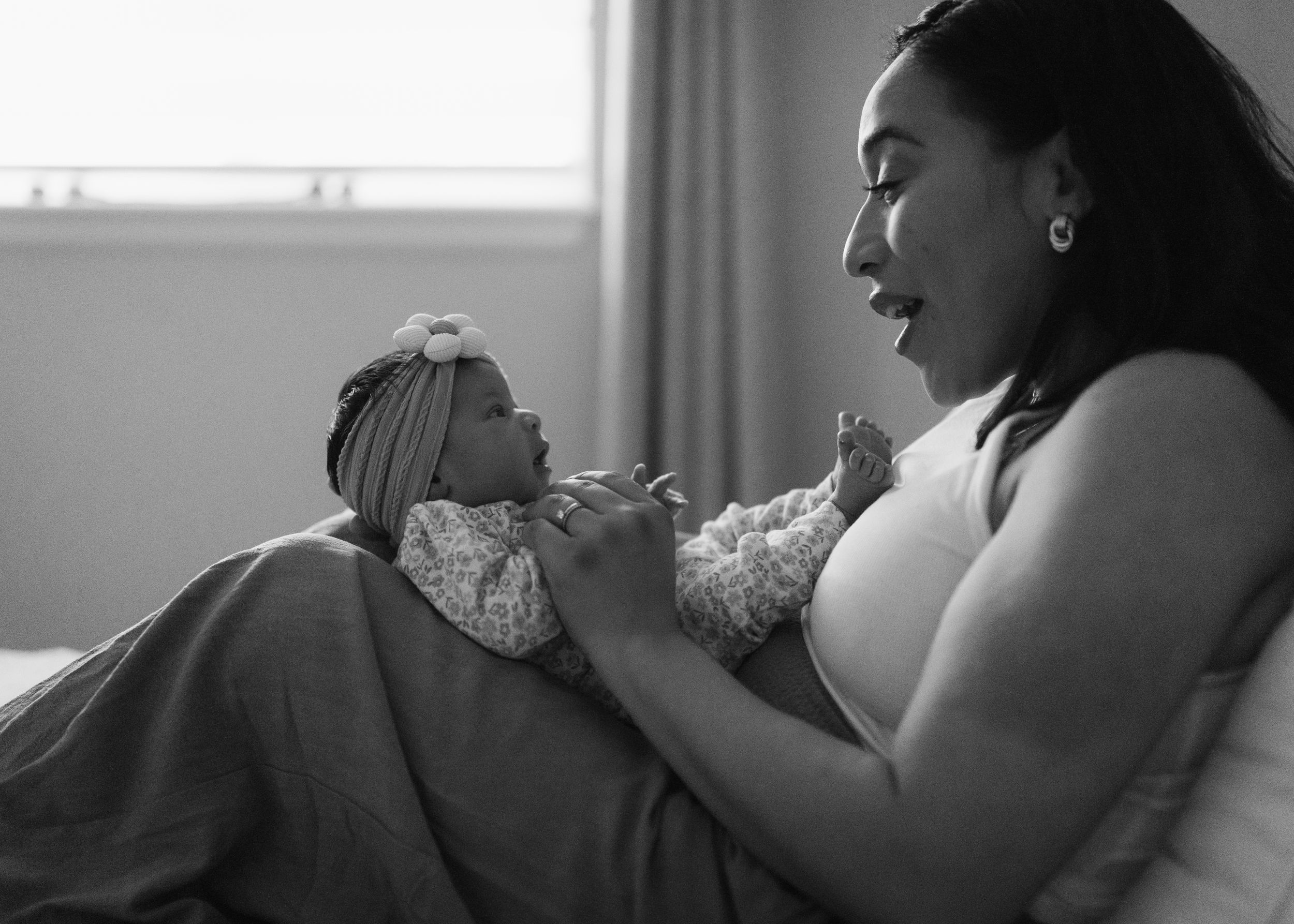 A series of black and white photos showing a person being comforted while lying in a hospital bed.
