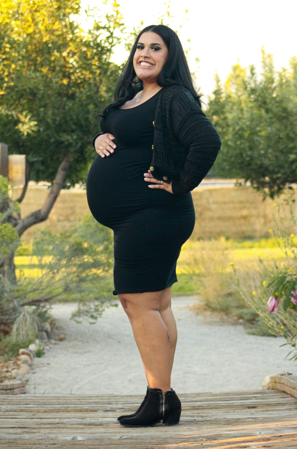 Full length maternity photo on wooden path with natural background.