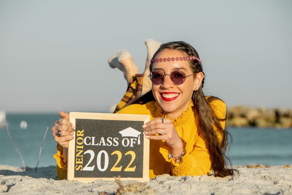 senior portrait of girl holding 2024 sign in New Port Richey