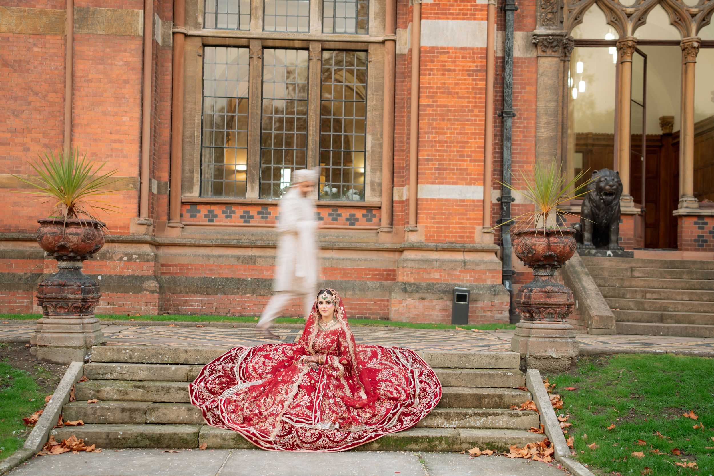 A historic red brick building exterior with ornate Victorian architecture and decorative stone details.
