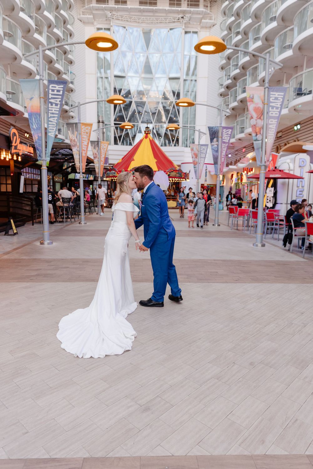 A bride and groom kissing in the carnival on the Oasis of the sea