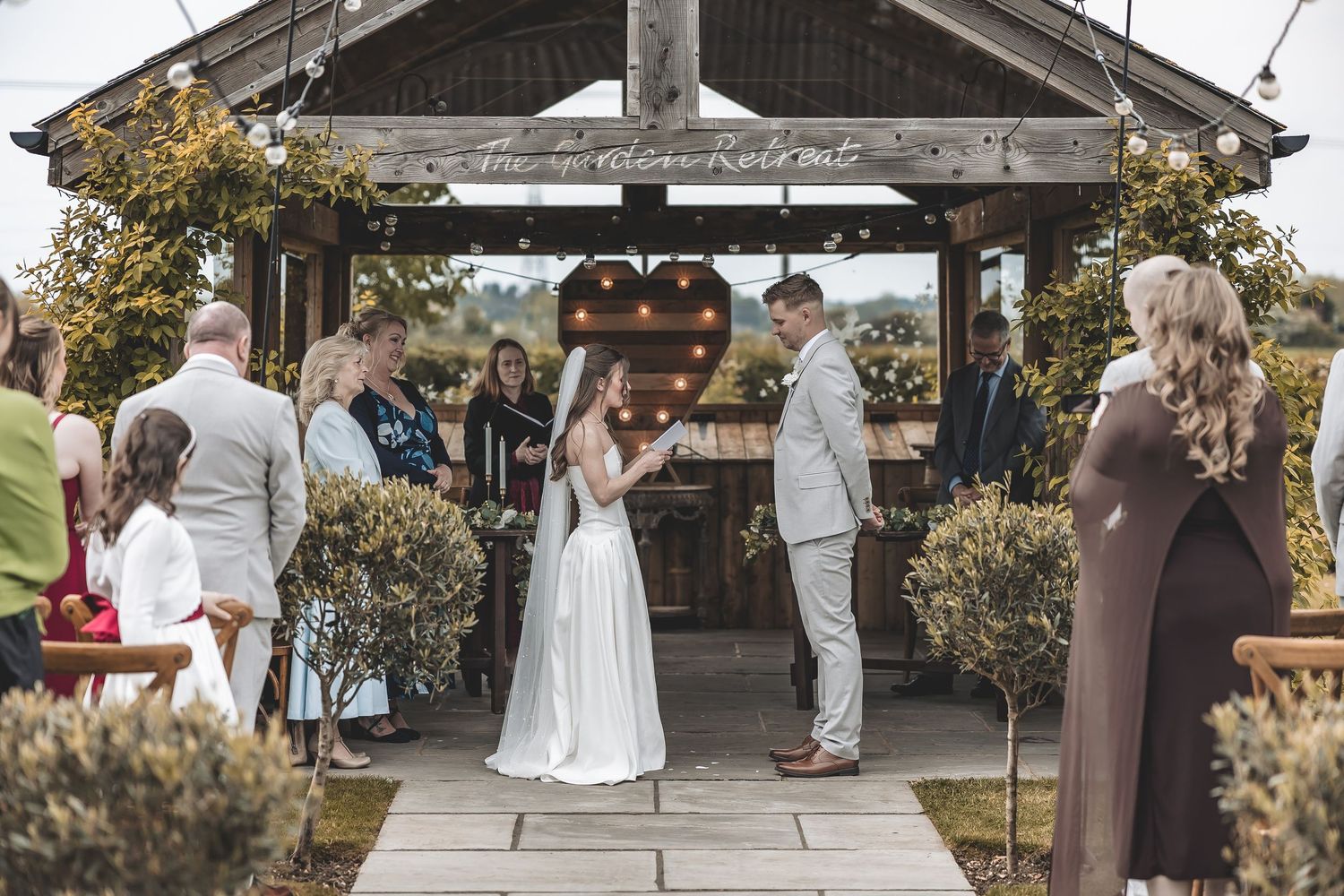 Documentary wedding ceremony at Beverley Barn with outdoor setup.