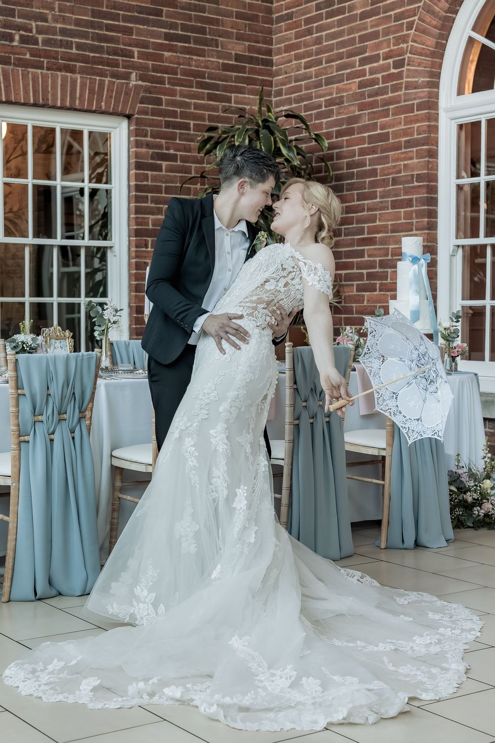 A natural fun moment during a attempted dip kiss between bride and bride.