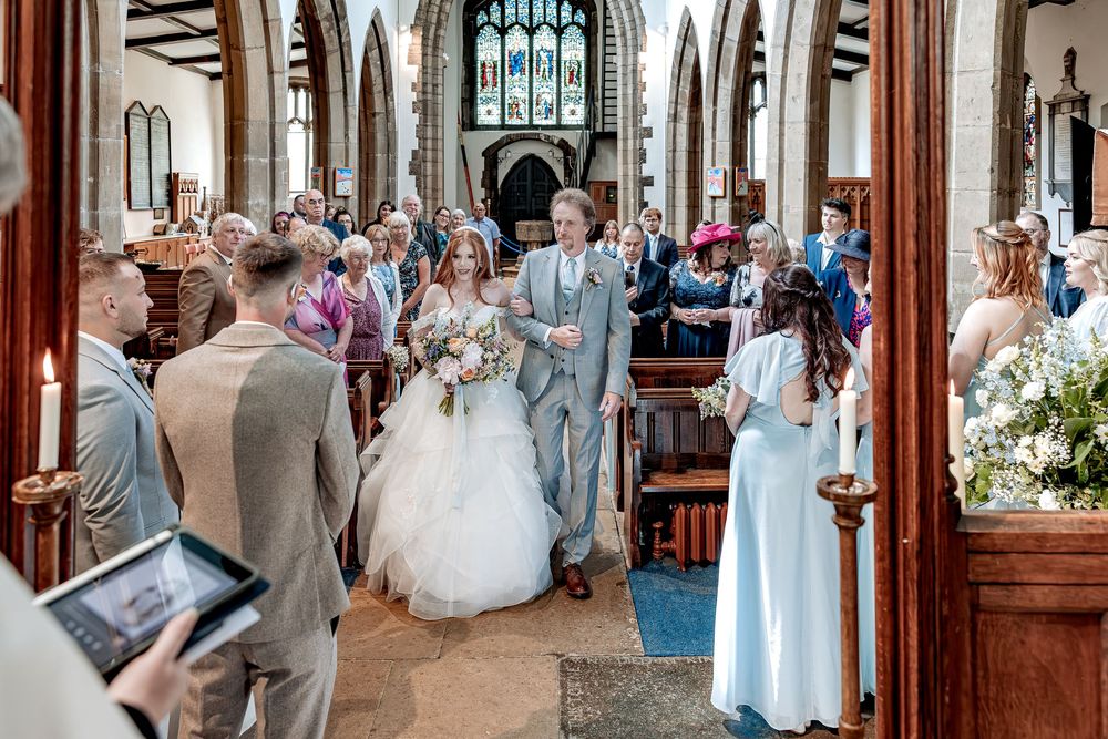A natural emotional moment captured as bride walks he daughter down the aisle to meet her husband.