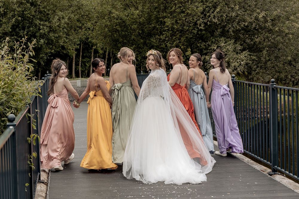 Documentary wedding photography capturing bride and bridesmaids on the bridge of her Yorkshire wedding venue.