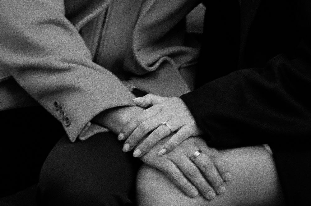 Black and white photo of couple holding hands showing engagement ring, romantic close-up shot. Aliza Dwokrind photography