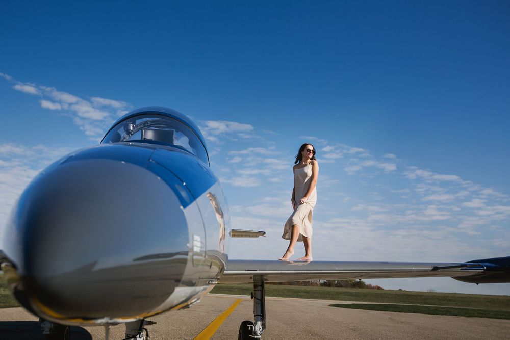 Modern High school senior portrait with jet plane in Howell Michigan; senior aviation photos by South Lyon, MI photographer