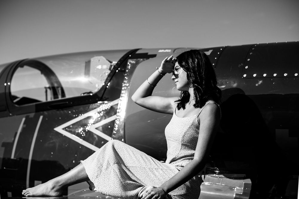 Modern editorial senior portrait with girl on jet plane in Howell Michigan; senior aviation photos by Brighton, MI photographer